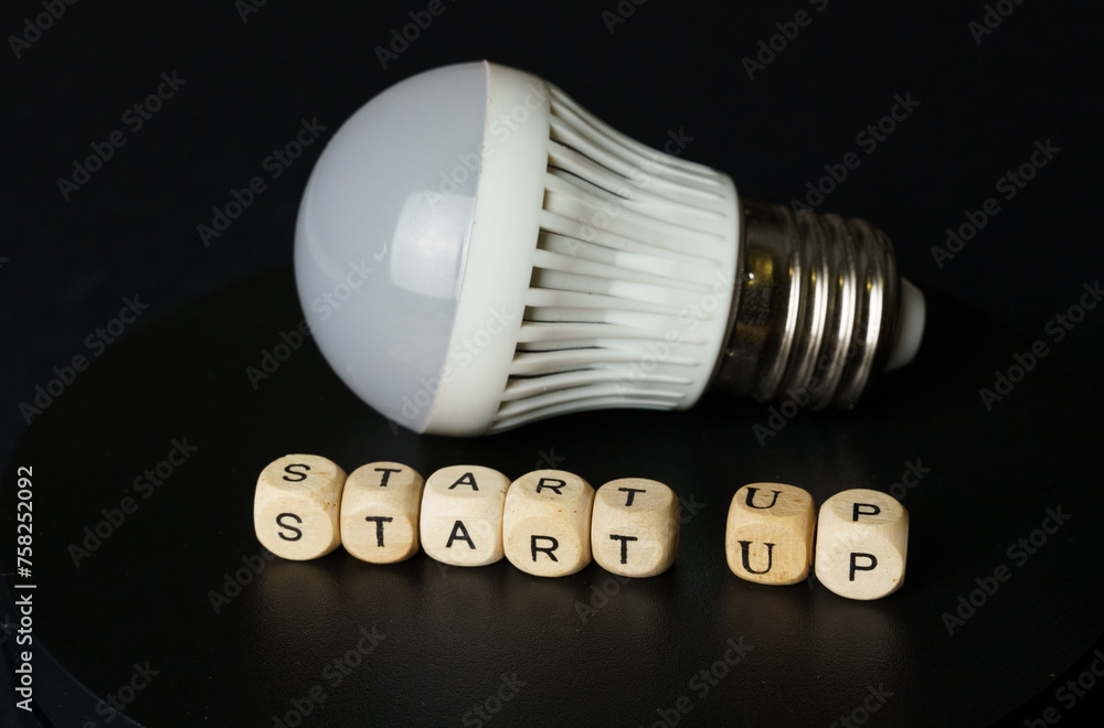 Startup Concept With Light Bulb and Letter Blocks Startup Concept With Light Bulb and Letter Blocks