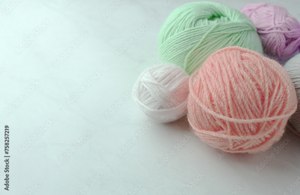 Colorful yarn balls on light background                
