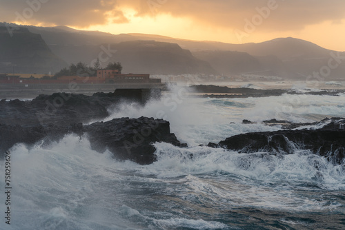 waves beating against the rocks in El Puertillo at sunset. Arucas. Gran Canaria. Canary islands