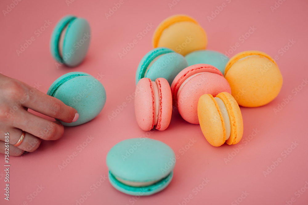The image is of a hand holding a colorful heart-shaped cookie 6204. The image is of a hand holding a colorful heart-shaped cookie 6204.