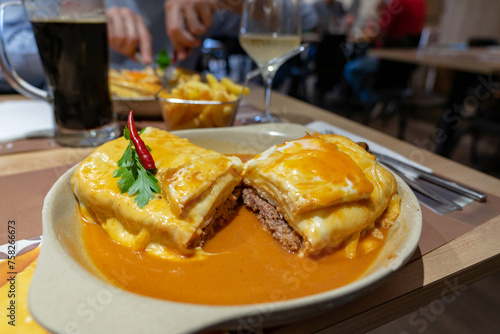 traditional delicious portuguese francesinha in a restaurant in Porto Portugal photo