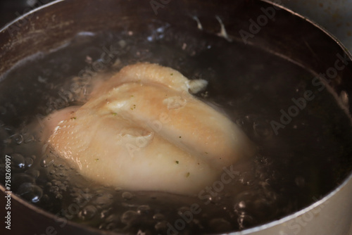 Photo of chicken boiled in a pot. Food preparation concept