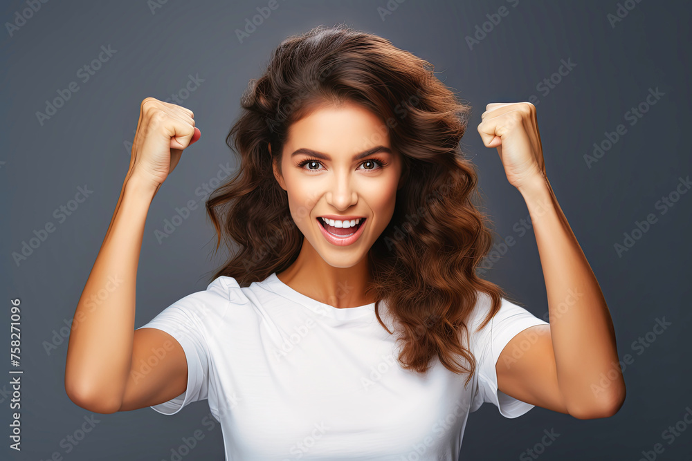 Fototapeta premium A woman standing with her arms stretched upward in the air.