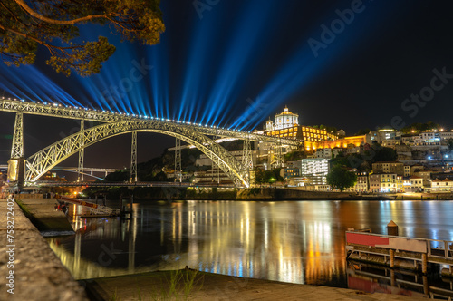 dom luiz brige lighht show in Porto on the riverside of Duero river cityscape at night © Bernadett