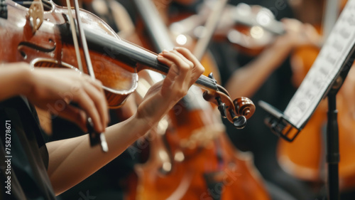 Violinists in an orchestra passionately perform with focus and synchronicity.