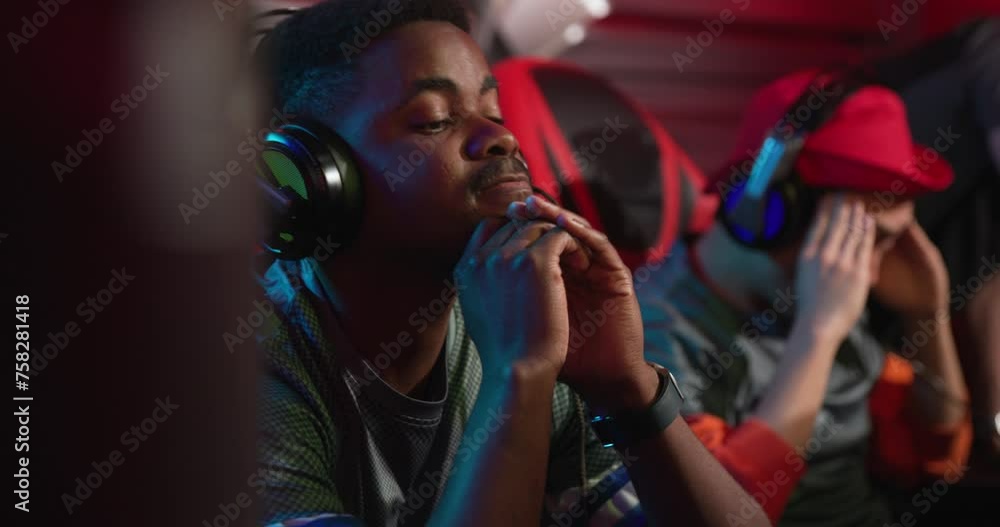 Gamers playing in a competitive gaming tournament Gamers playing in a competitive gaming tournament