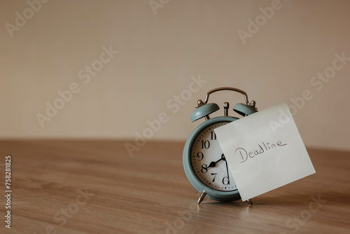 alarm clock with pos-it and the word 