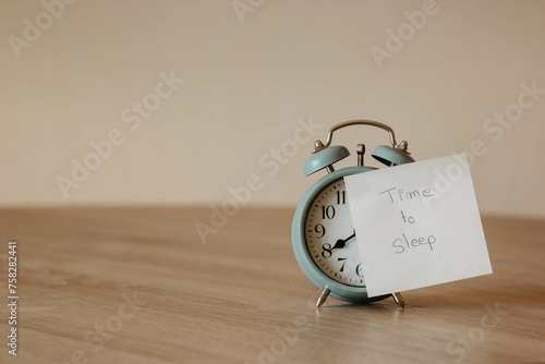 Time to sleep. Alarm-clock with post-it and the sentence 