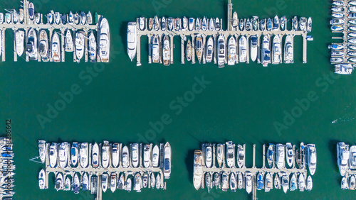 Aerial View by Drone of Yacht Club and Marina. Top view of yacht club. White boats in sea water
