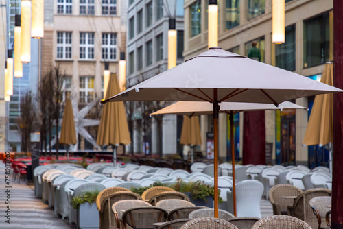 Photography Tables and seats with parasols inside a mall