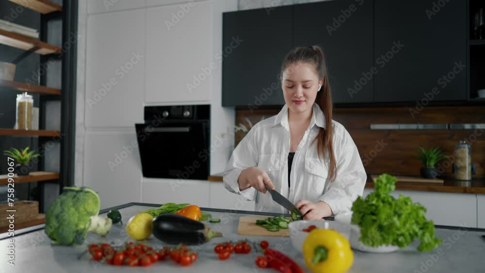 Young woman cooking, dancing at kitchen. Girl cook food listen music with headphones and dancing in spacious kitchen. Girl with vegetables play radio and dance, while cooking salad have fun at home. Young woman cooking, dancing at kitchen. Girl cook food listen music with headphones and dancing in spacious kitchen. Girl with vegetables play radio and dance, while cooking salad have fun at home.