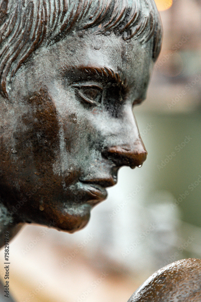 Fototapeta premium Bronze sculpture of Three Girls and a Boy on the bank of Spree River, Berlin, Germany
