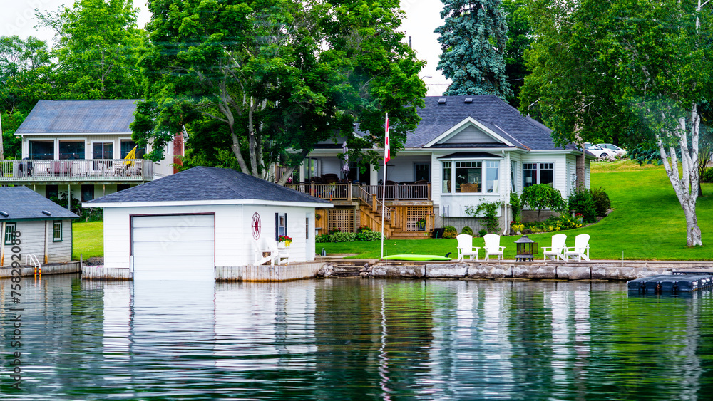 Ontario lake, Canada - June 24 2018: Cruise boat and resorts with deck in Ontario Lake Ontario lake, Canada - June 24 2018: Cruise boat and resorts with deck in Ontario Lake