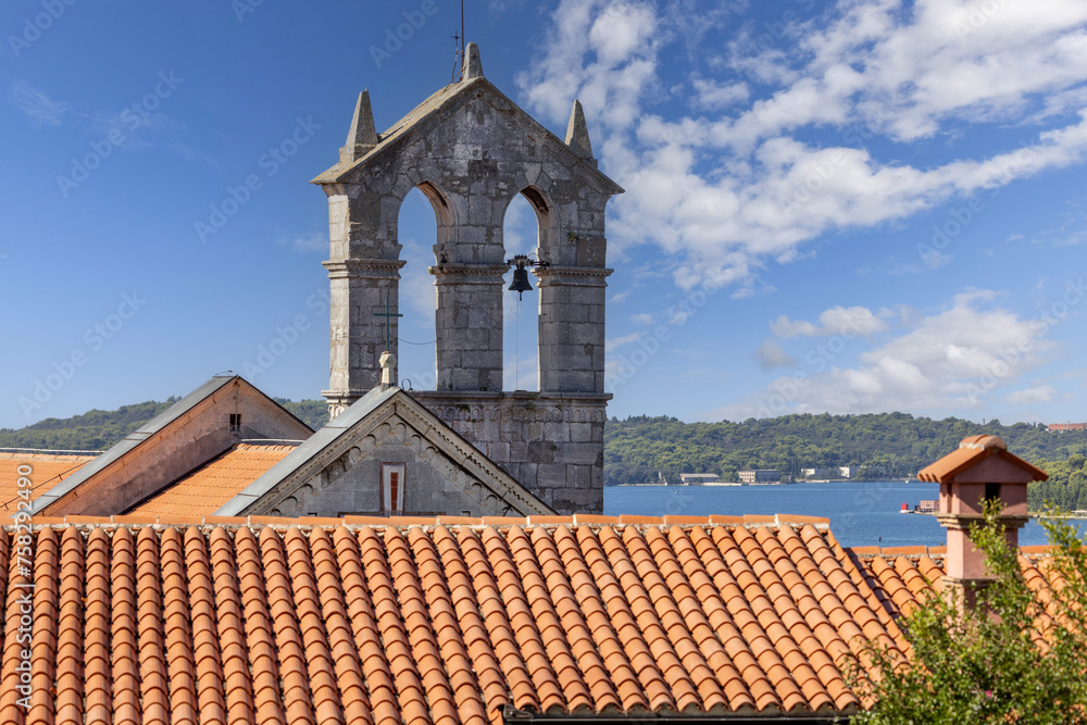 Obraz premium Medieval Monastery and Church of St. Francis with bell tower located on Pula Hill, Pula, Croatia, Istria