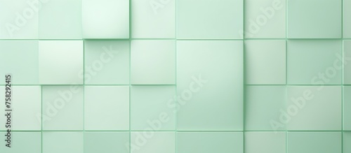 A close up of a tile wall in shades of azure and aqua. The rectangular tiles create a symmetrical pattern with parallel lines, giving an electric blue flooring effect