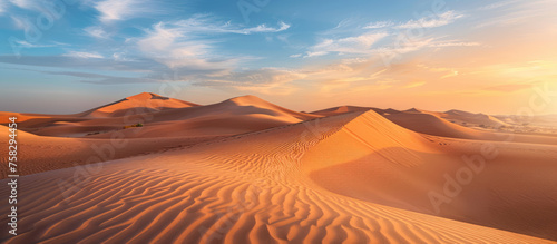 The vast desert expanse is bathed in the magical light of sunset, highlighting the patterns of the dunes