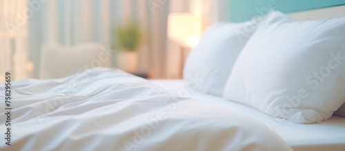 A comfortable bed with white linens  pillows  and a mattress on a sturdy hardwood bed frame in a cozy bedroom setting