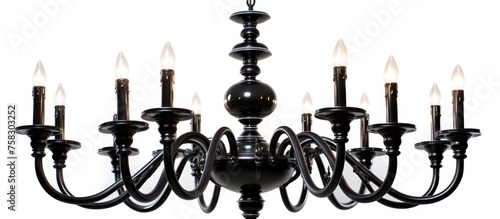 A monochrome photography of a black chandelier with candles hanging from the ceiling on a white background. The symmetry of the design creates a beautiful circle shape, resembling a fashion accessory © TheWaterMeloonProjec