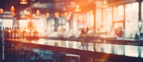 An image of a lively bar in the city with patrons sitting at the wooden bar counter. The blurred effect gives off an artsy and entertaining vibe photo