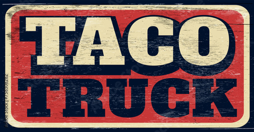 Aged and worn taco truck sign on wood