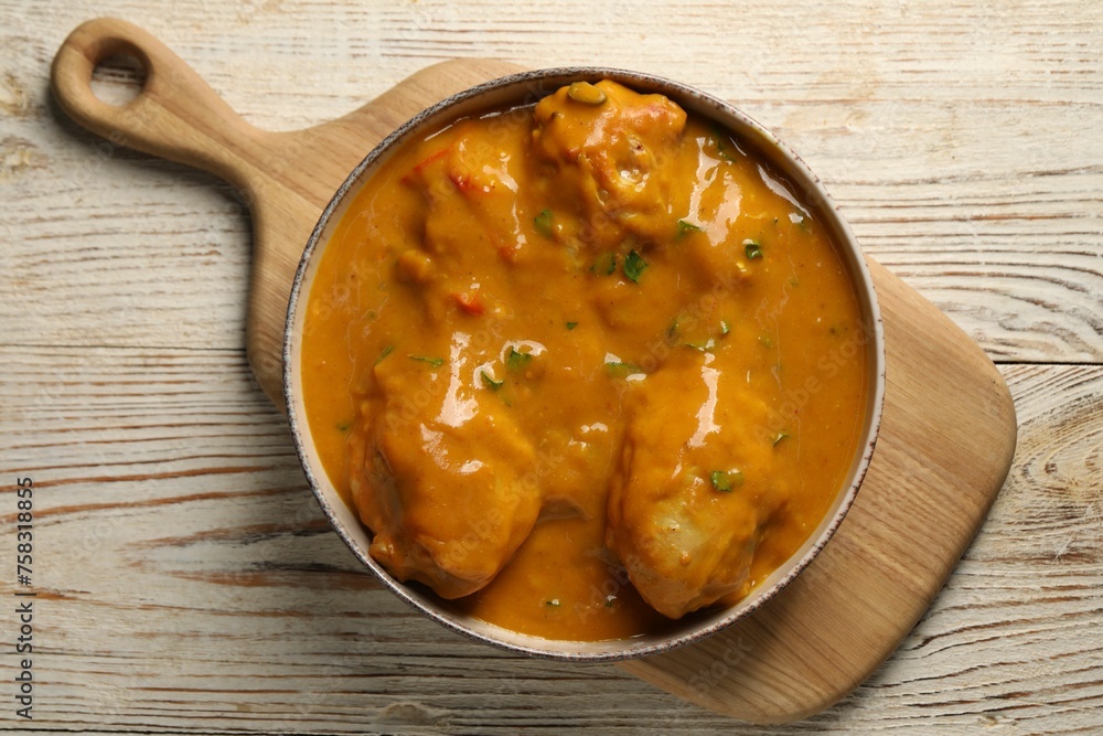 Tasty chicken curry on wooden table, top view Tasty chicken curry on wooden table, top view