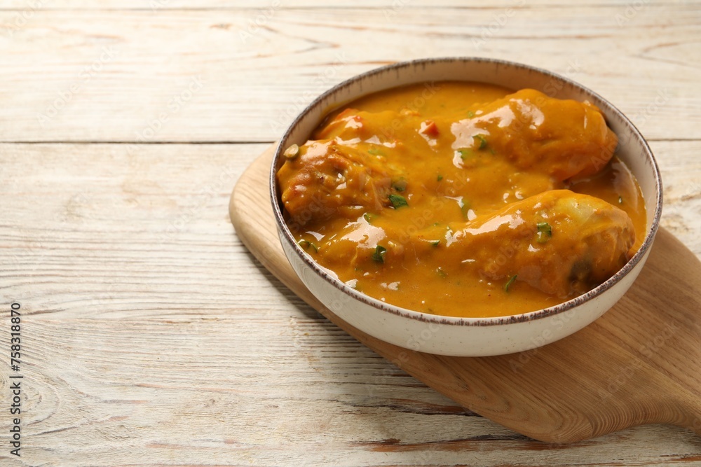 Tasty chicken curry on wooden table, closeup. Space for text Tasty chicken curry on wooden table, closeup. Space for text