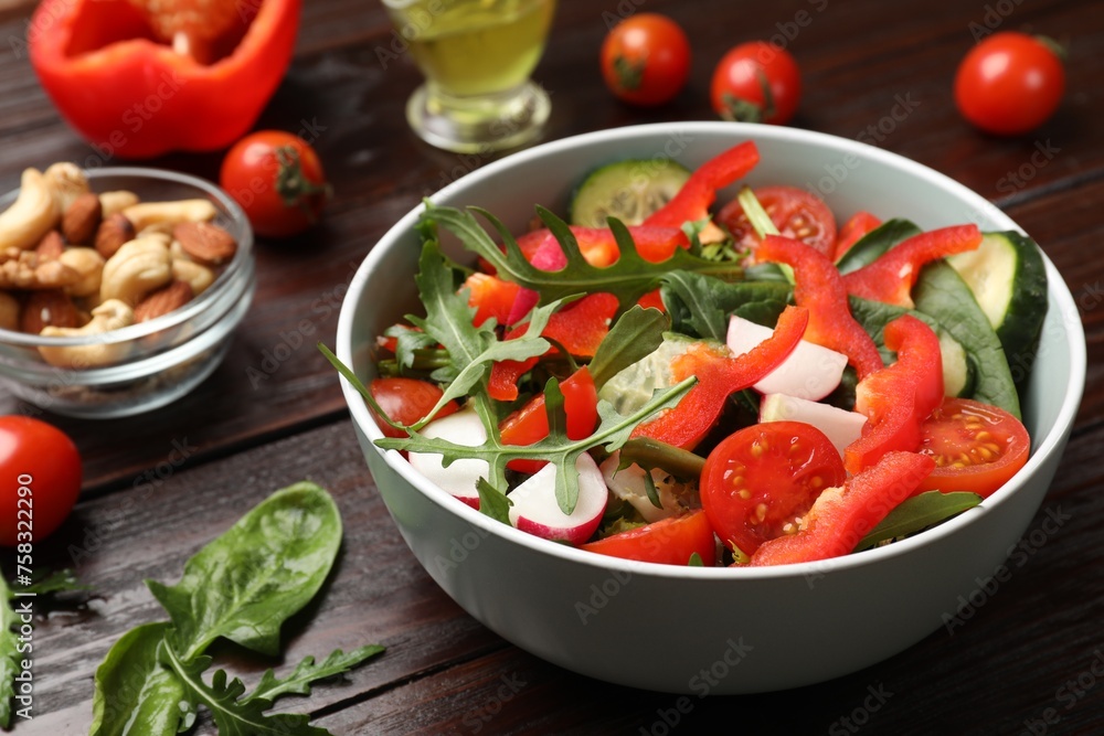 Tasty fresh vegetarian salad on dark wooden table Tasty fresh vegetarian salad on dark wooden table