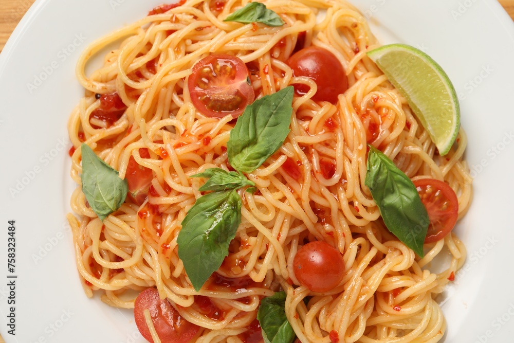 Vegetarian meal. Tasty pasta with fresh tomatoes and basil on white plate, top view