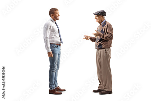 Man in jeans and white shirt standing and listening to an elderly man
