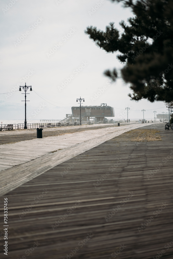 Desolate Boardwalk Leading to a Distant Building in New York