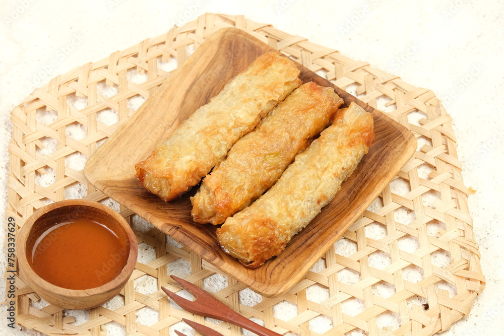 Lumpia Kulit Tahu, chicken shrimp spring rolls wrapped in tofu skin. Served with chilli sauce Lumpia Kulit Tahu, chicken shrimp spring rolls wrapped in tofu skin. Served with chilli sauce