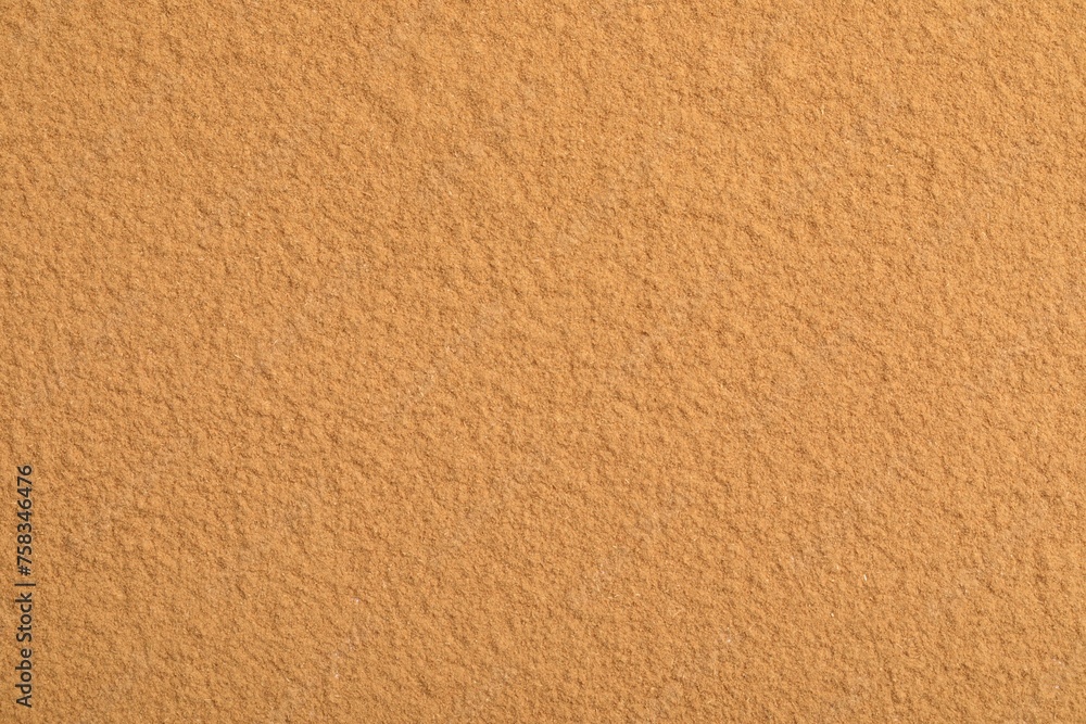 Dry aromatic cinnamon powder as background, top view Dry aromatic cinnamon powder as background, top view