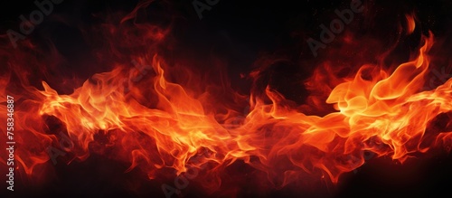 A close up of a fiery orange flame against a black background resembling a beautiful astronomical object in the sky, emitting heat and gas