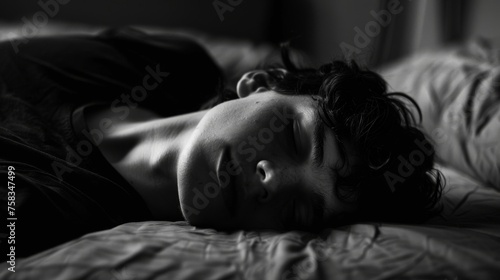 A monochrome image highlighting a young man in deep sleep, emanating a sense of peace and solitude in a modern context © ChaoticMind