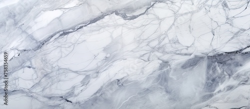 A detailed shot of a white marble texture resembling an icy landscape. The smooth surface evokes images of snowcovered slopes and freezing winds