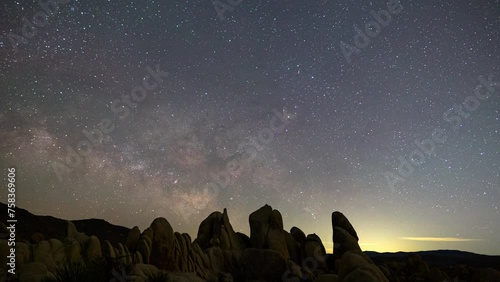 Wallpaper Mural Timelapse of Milky Way galaxy rising over rugged boulders in Joshua Tree National Park, California  Torontodigital.ca