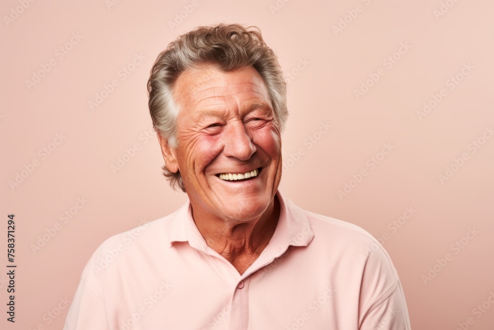 Portrait of a happy senior man laughing against a pink background. Portrait of a happy senior man laughing against a pink background.