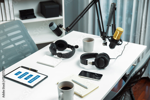 Modern office studio equipment microphone setting, laptop, tablet and headphone prepared with coffee on live streaming with empty host channel steamer podcast social media online concept. Postulate.