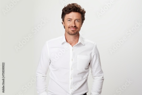 Portrait of handsome man in white shirt looking at camera and smiling