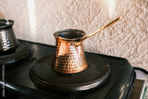 Copper coffee pot on electric stove. Turkish coffee in the cezve
