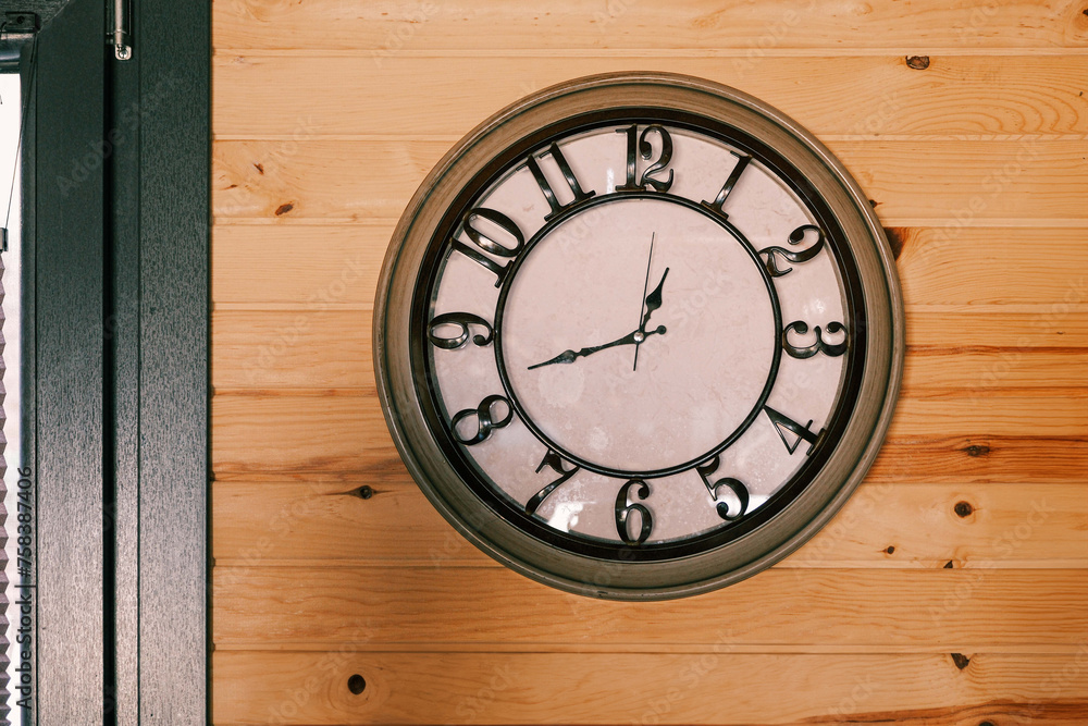 Black and white clock on wooden wall, free copy space