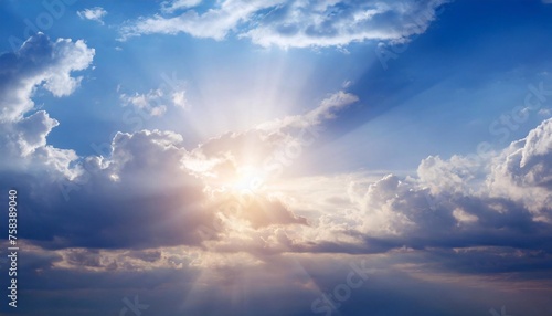 Blue sky with white clouds and sunbeams. Nature background.