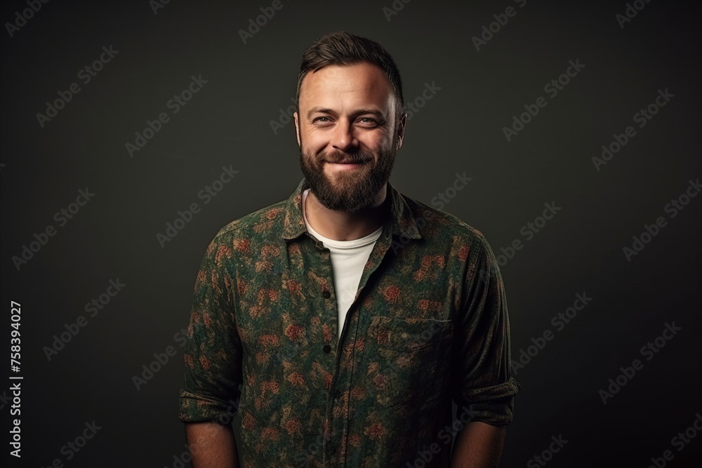 Portrait of handsome bearded man looking at camera over dark background. Portrait of handsome bearded man looking at camera over dark background.