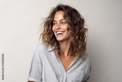Portrait of a beautiful young woman laughing and looking at the camera © Igor