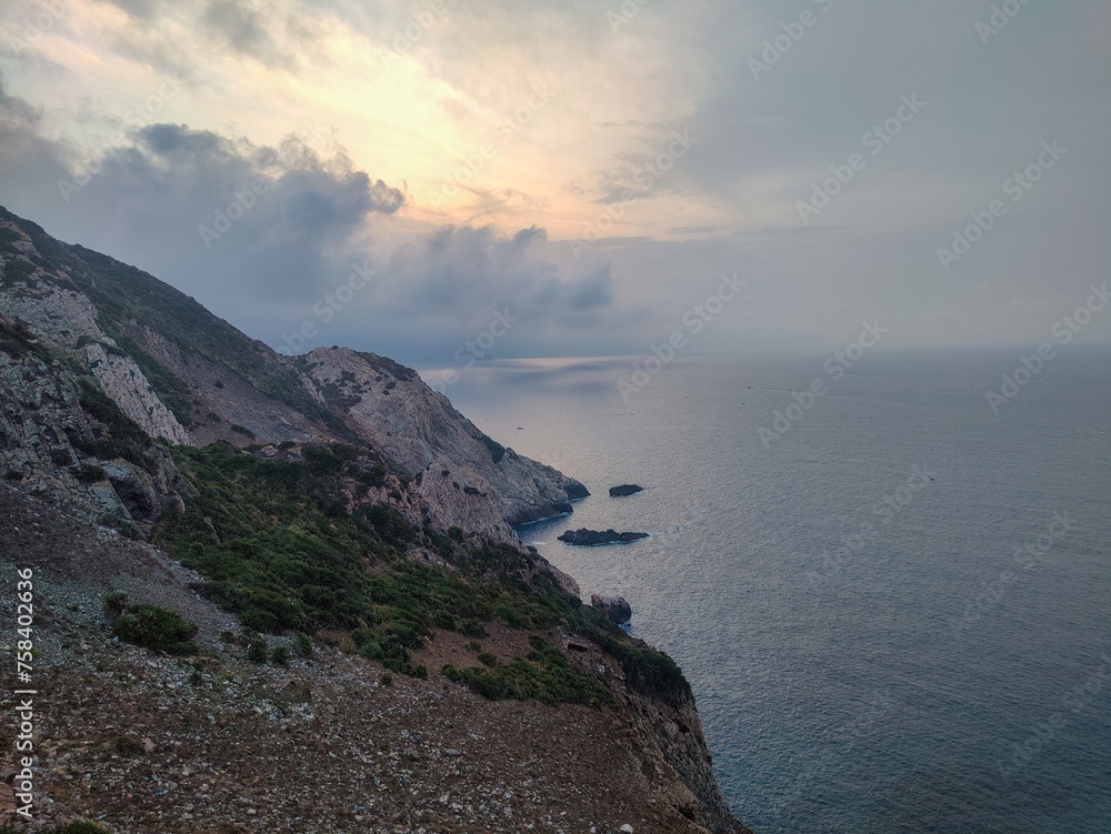 rocky coast under clody sky at cap de garde lighthouse at sunset in Annaba