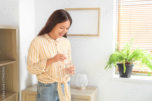 Young Asian woman with glas...