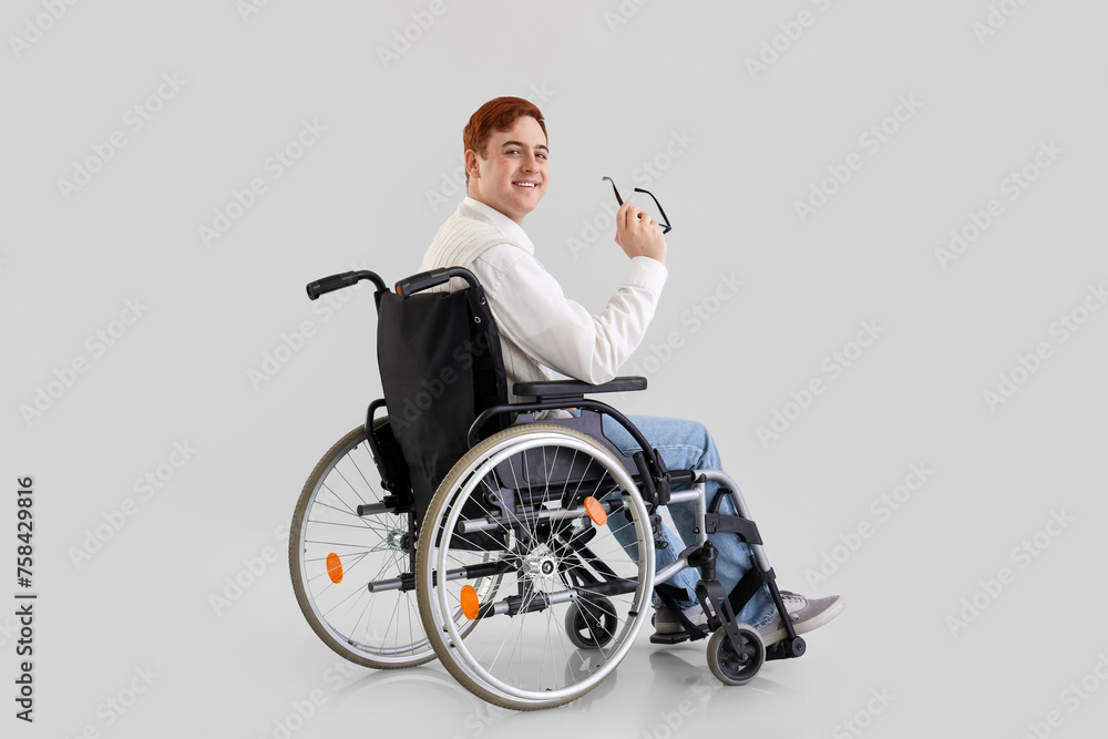 Office worker in wheelchair with eyeglasses on light background Office worker in wheelchair with eyeglasses on light background