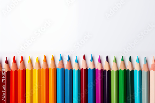 A row of colorful pencils lined up on a white background
