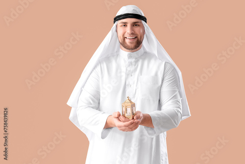 Young Muslim man with lamp ...