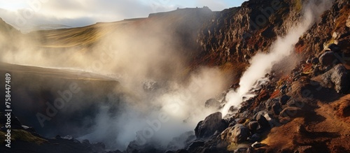 A cloud of smoke is rising from a volcano on the mountains, creating a spectacular meteorological event in the natural landscape